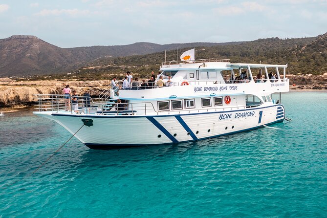 Blue Lagoon cruise: giant slide, music & Paphos hotel transfers - Latchi Harbor departure: live music, open-air fun, and time on the water