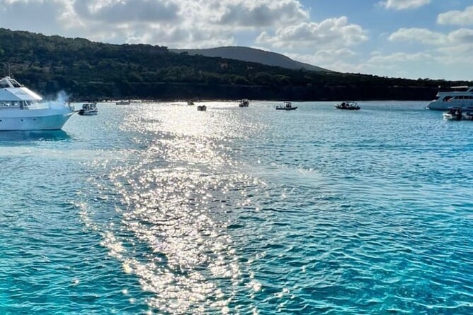 Blue Lagoon cruise: giant slide, music & Paphos hotel transfers - Manolis Bay and Fontana Amorosa: turquoise water breaks between the main event